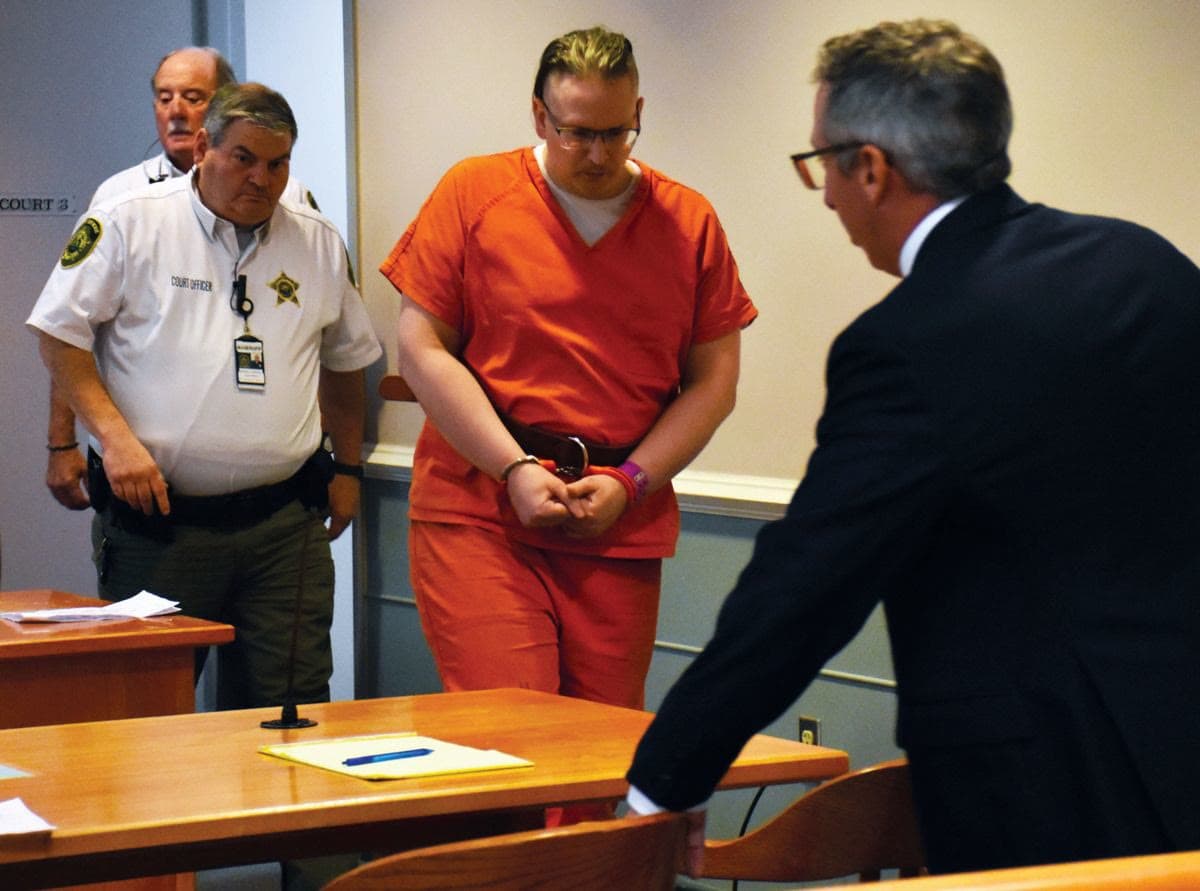 Douglas Herlihy is escorted into court