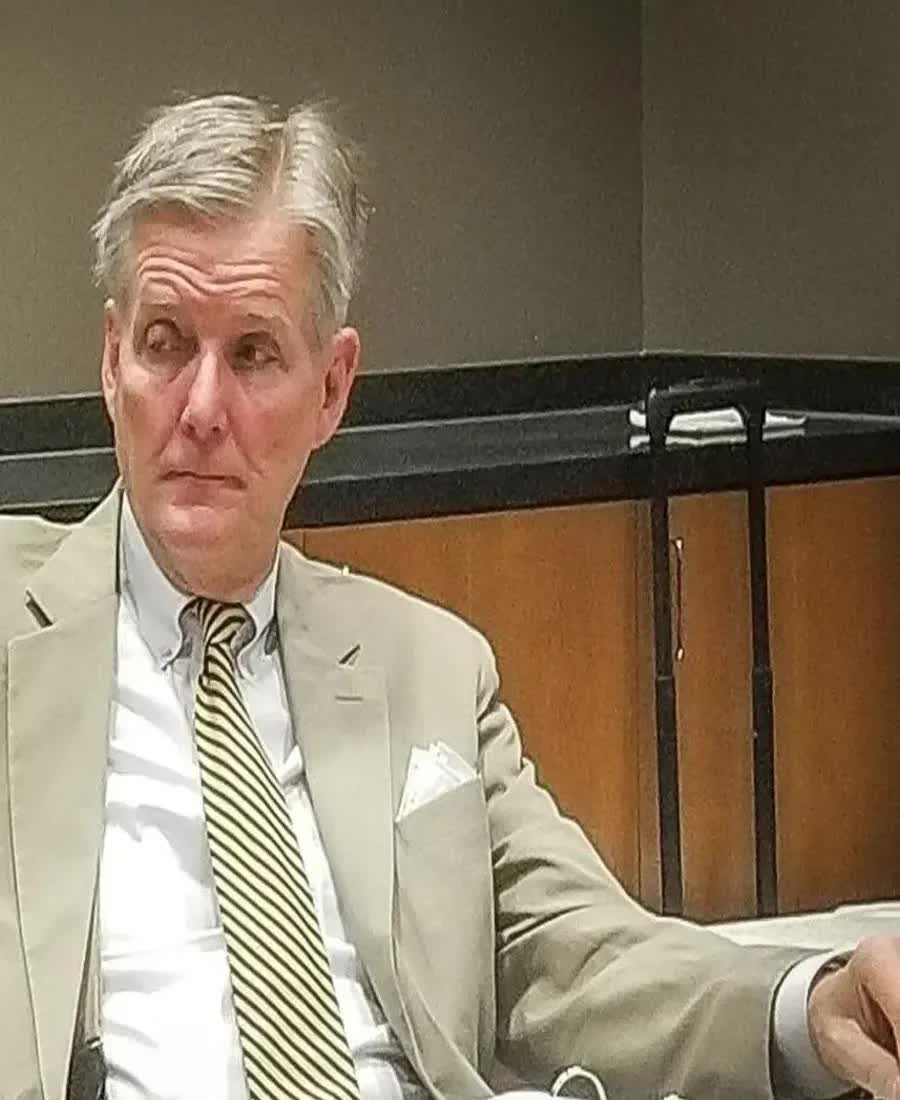 Edwin Brant Frost IV seated at a table in a suit