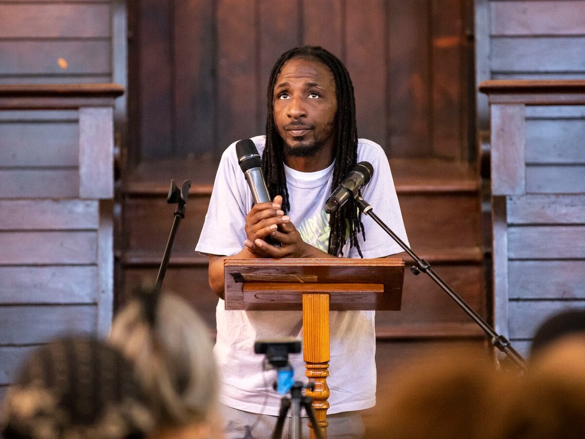 Hassan Bennett speaking at a microphone