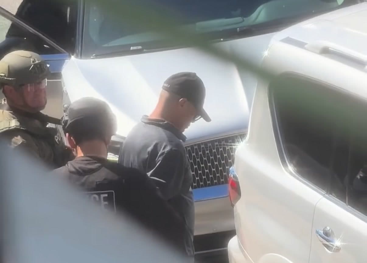 Jose Antonio Zayas detained by officers after his arrest