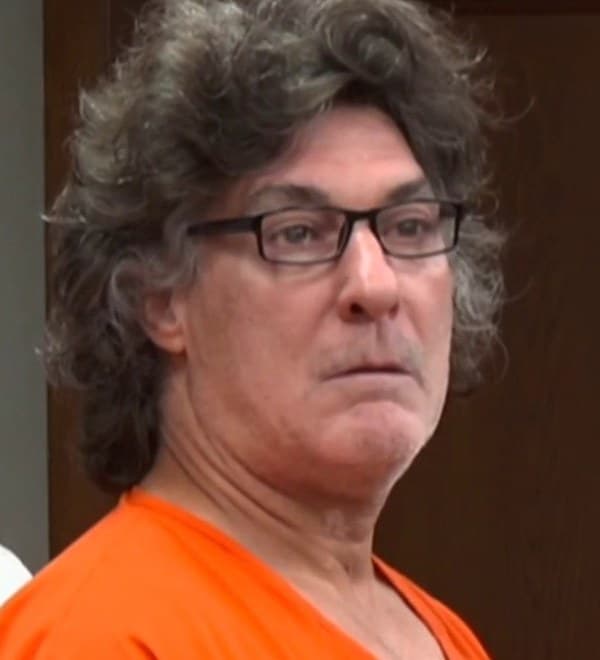 Onelio Castro-Arroyo seated in court in an orange jail uniform